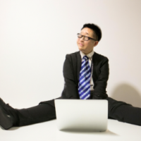 I need one generate picture office boy with laptop and desk age 30 years with office clothing real boy 